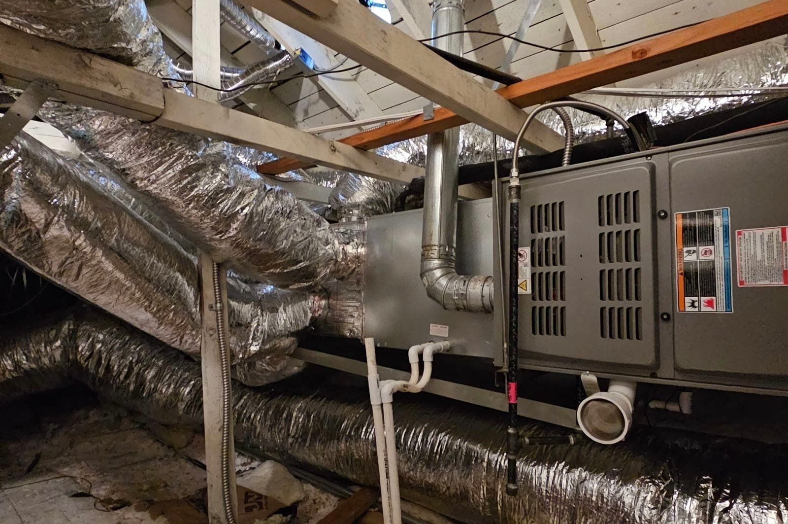 A room with a lot of pipes and a heater.