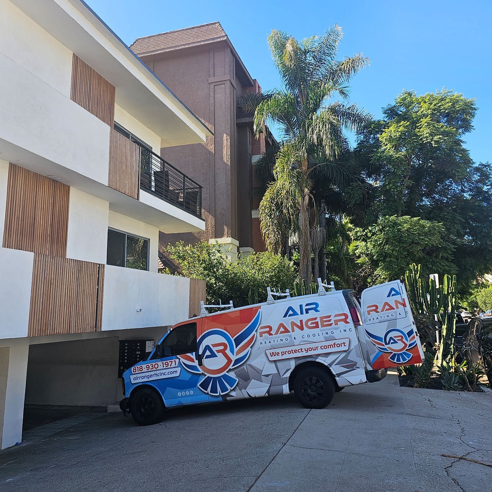 An air ranger van is parked in front of a building