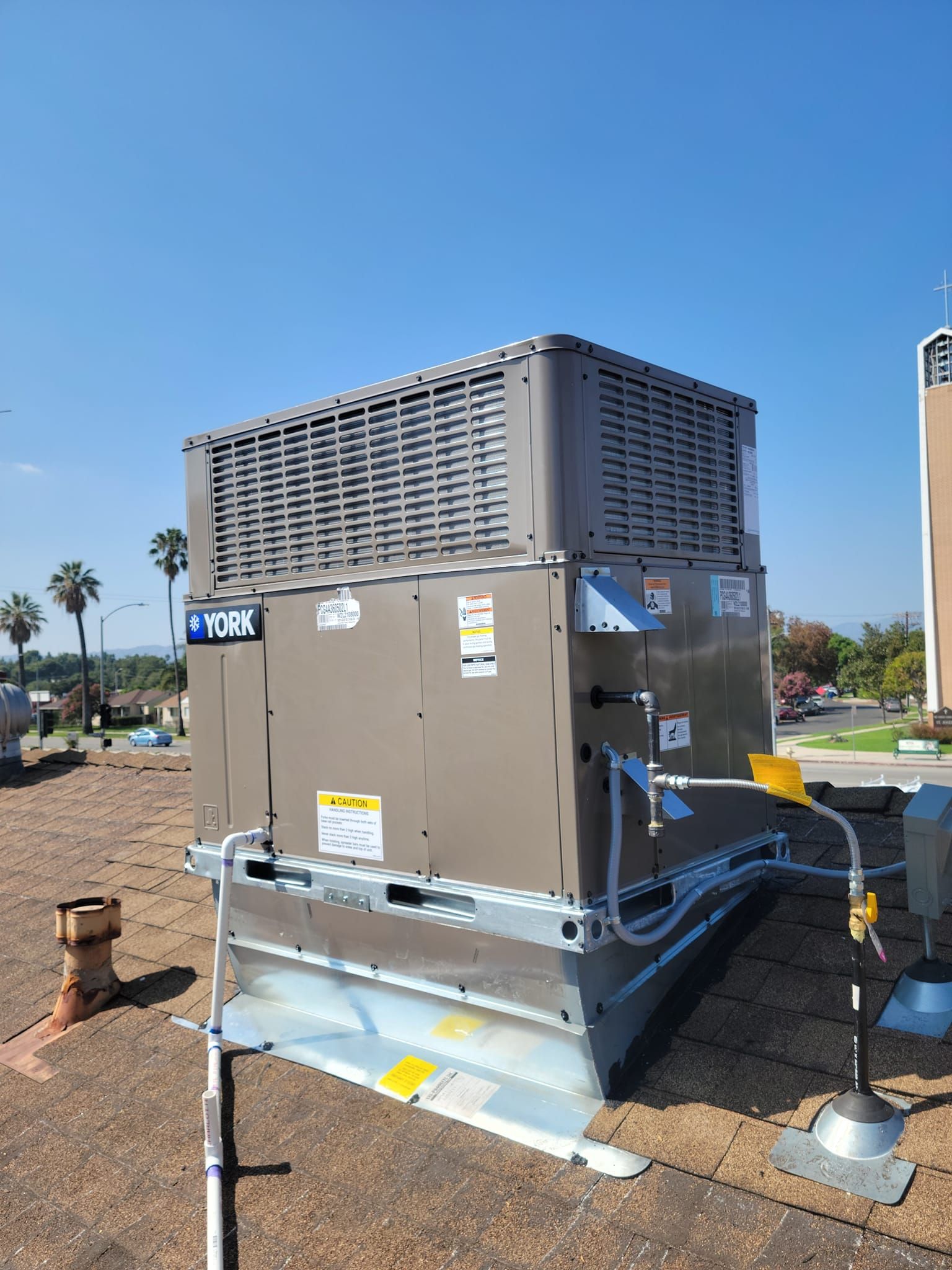 A large air conditioner is sitting on top of a dirt field.