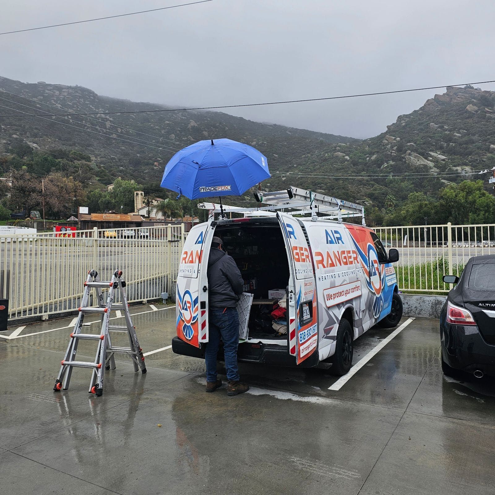 A ranger van is parked in a parking lot