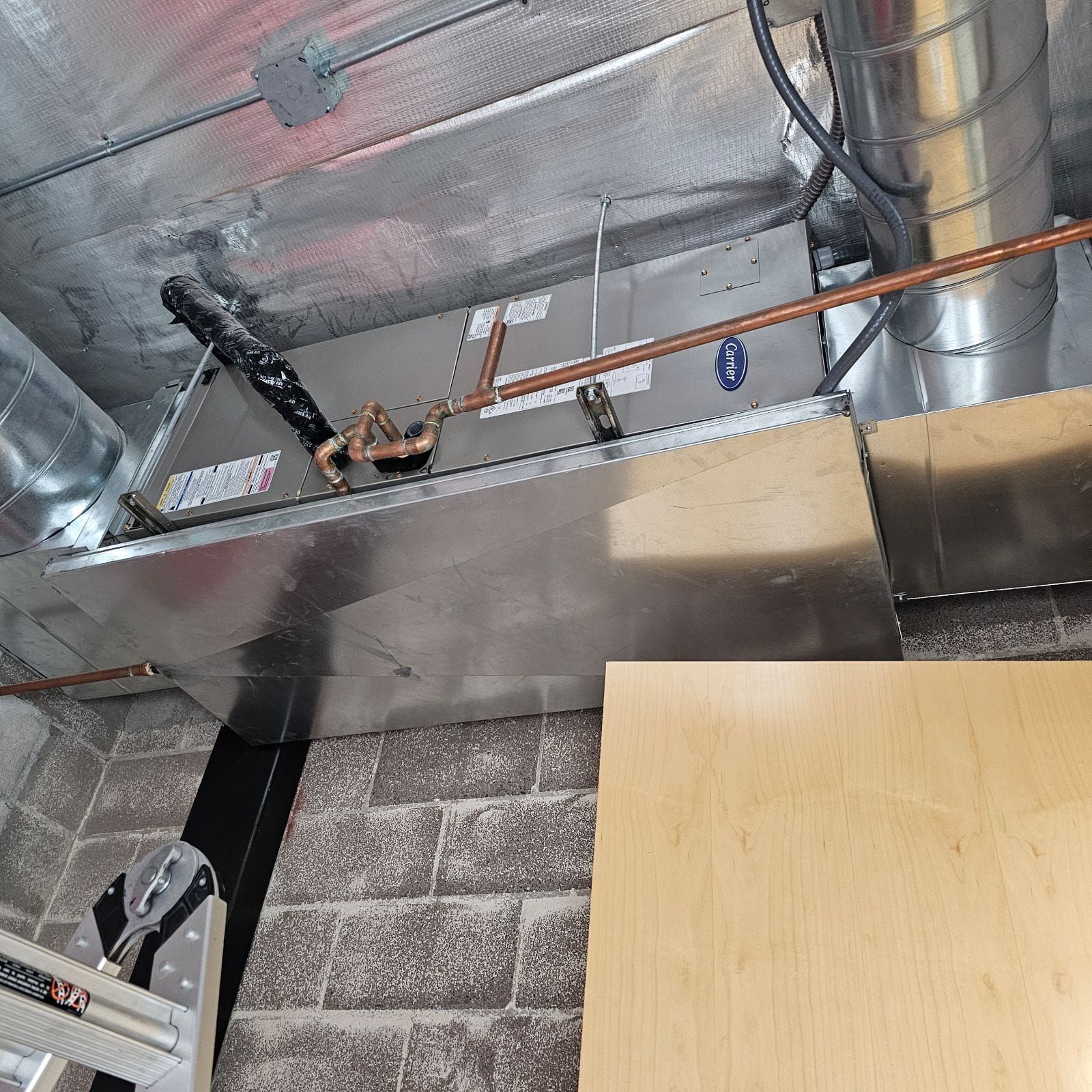 A ceiling with a lot of pipes coming out of it.