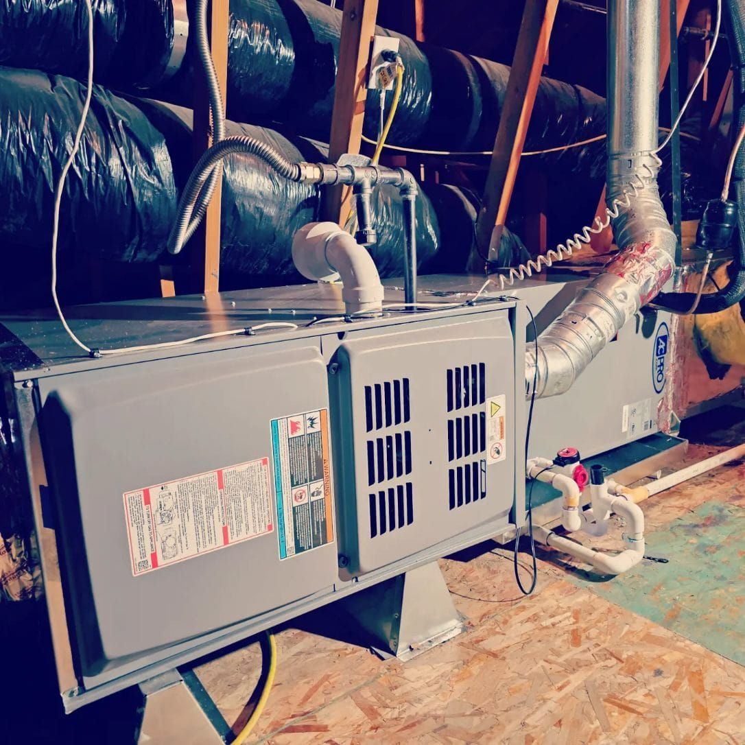An air conditioner is sitting in the attic of a house.