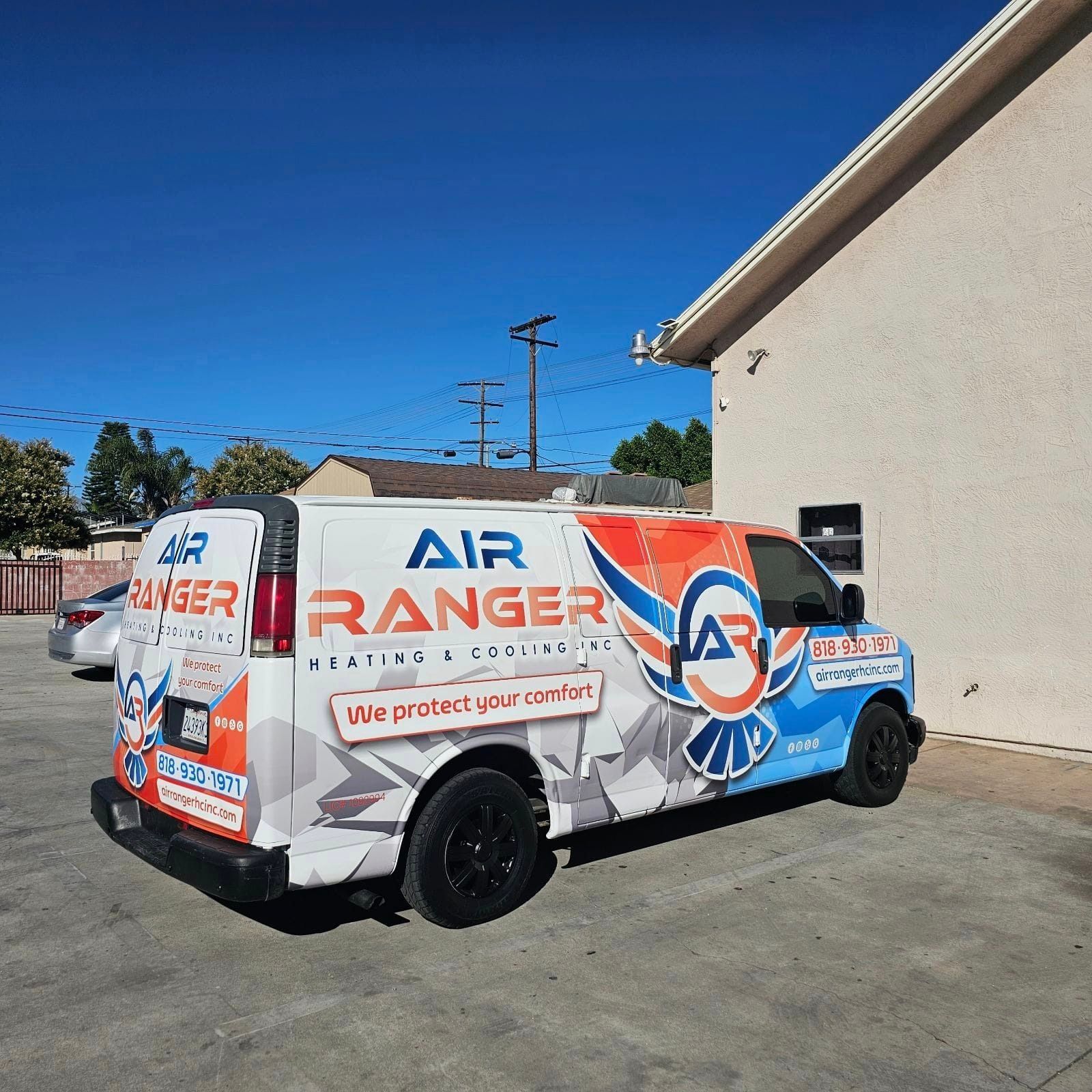 An air ranger van is parked in front of a building