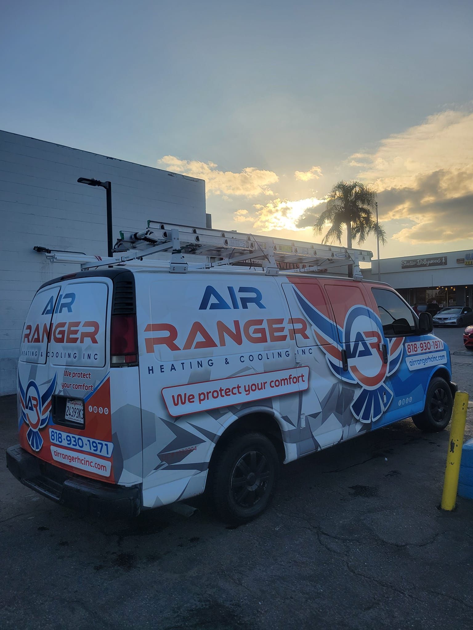 An air ranger van is parked in front of a building.
