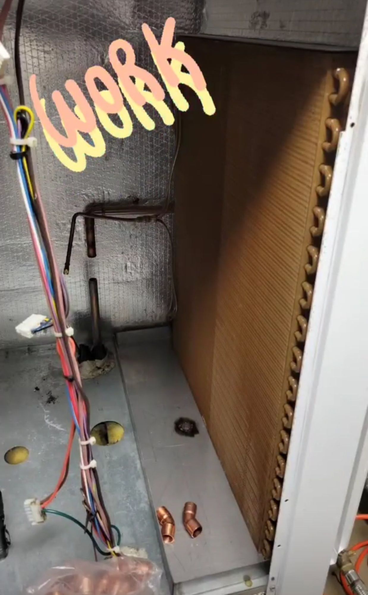 A room with a lot of wires coming out of it and a sign that says `` work ''.