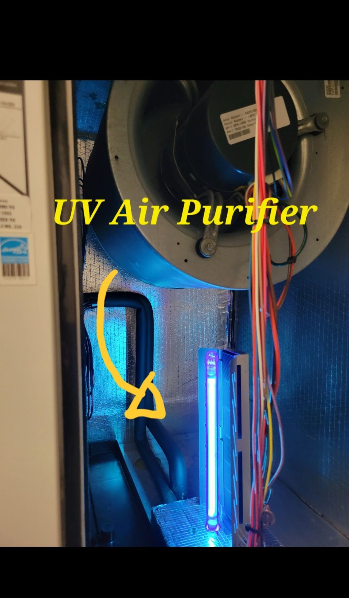A picture of a uv air purifier with a fan in the background