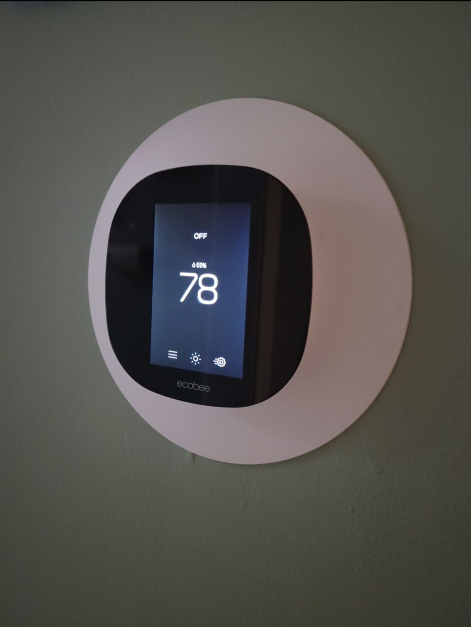 A thermostat on a wall that is set to 78 degrees