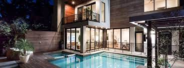 A large house with a swimming pool in front of it.