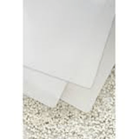 Two white towels are stacked on top of each other on a carpet.