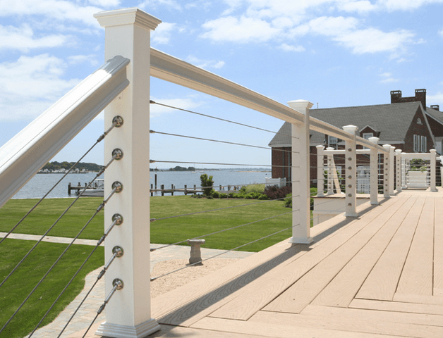 A white railing with a house in the background