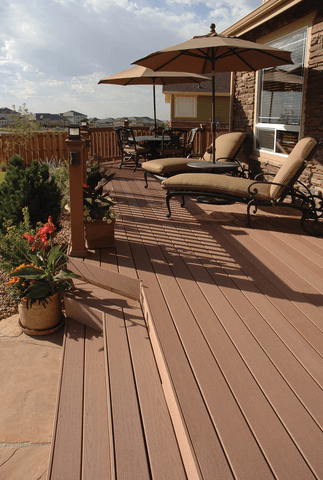 A deck with chairs and umbrellas on it