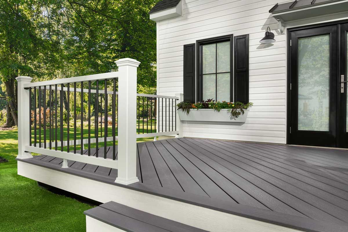 Trex® Decking from Budget Home Supply Colorado - White house with a gray composite deck and black railing.
