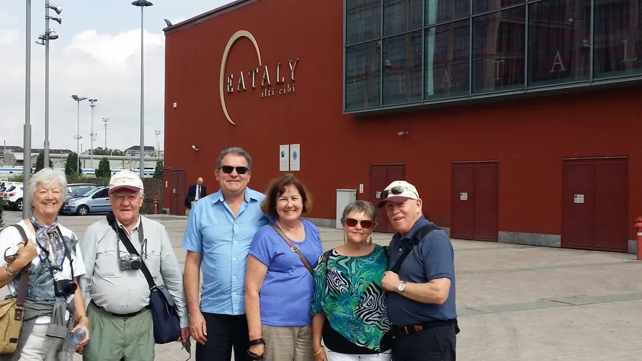 Group posing outside Eataly—Italy’s upscale food hall. Casual outfits, cameras ready, all smiles.
