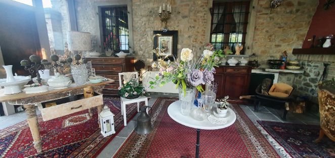A living room filled with furniture and a table with flowers on it.