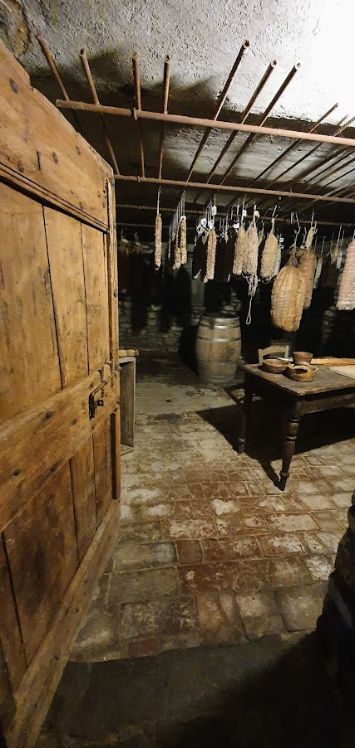 A room with a wooden door and a table in it.