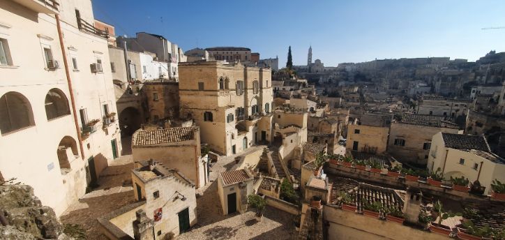 An aerial view of a city with a lot of buildings on a hillside.