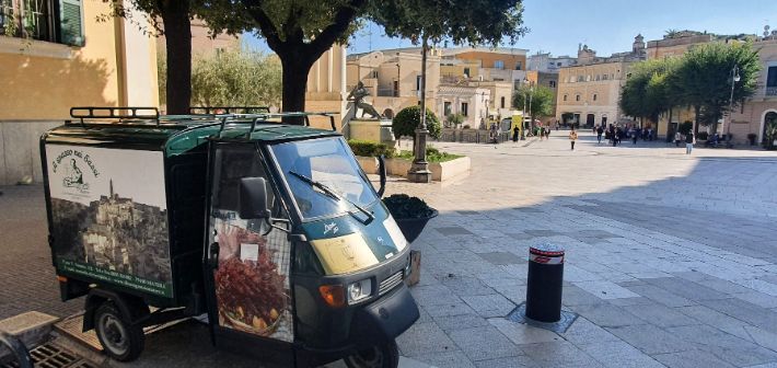 A small van is parked on the side of the road.