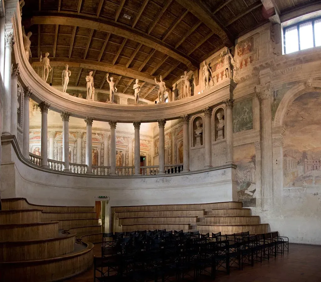 Historic Italian theater with wooden seating and classical statues.
