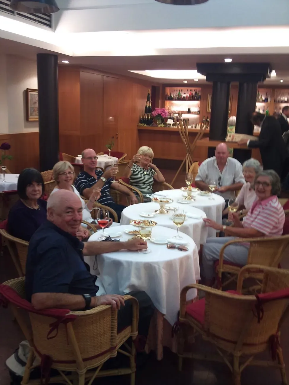 Group enjoying wine and appetizers at a cozy indoor restaurant.