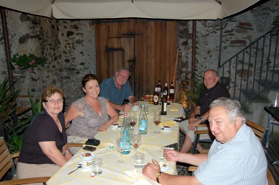 Outdoor dinner with friends and wine.