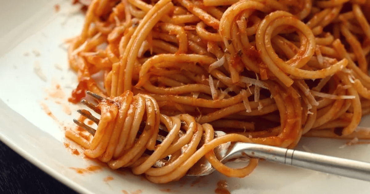 Plate of spaghetti with tomato-based sauce.