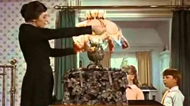 Scene from Mary Poppins, showing her pulling a lamp from her magical carpetbag.