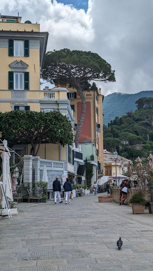A group of people walking down a street in front of a building