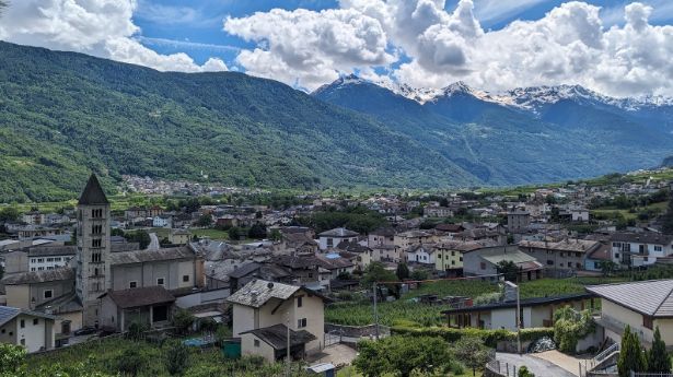 An aerial view of a small town with mountains in the background.