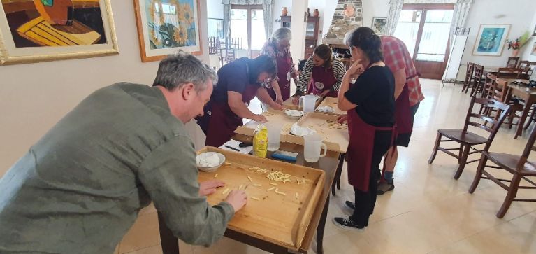 A group of people are standing around a table in a room.