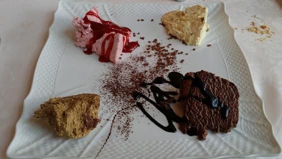 A white plate with a variety of desserts on it