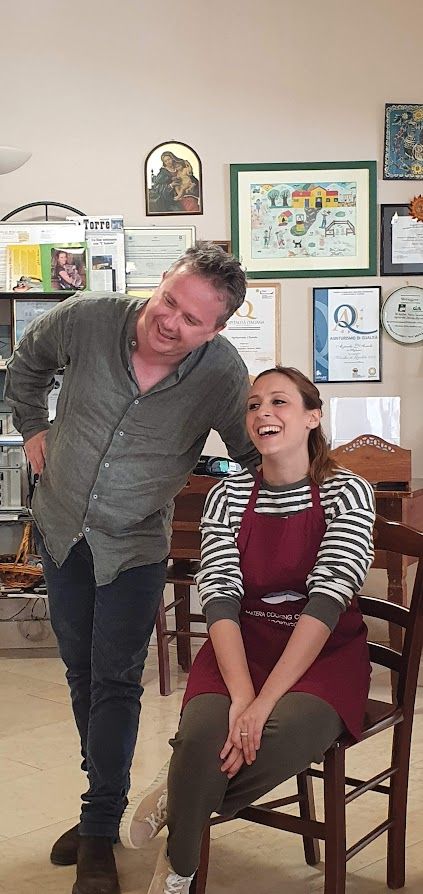 A man and a woman are standing next to each other in a room.