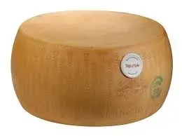A whole wheel of Parmigiano-Reggiano cheese with a stamped rind and quality certification label.