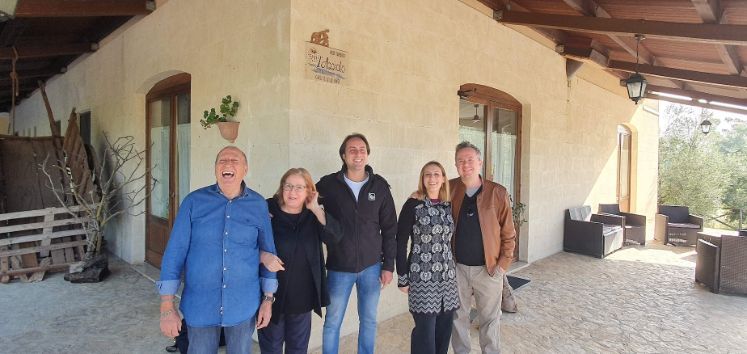 A group of people are posing for a picture in front of a building.
