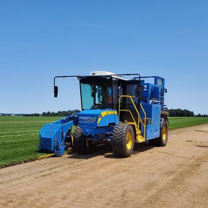 A man is driving a case tractor in a field