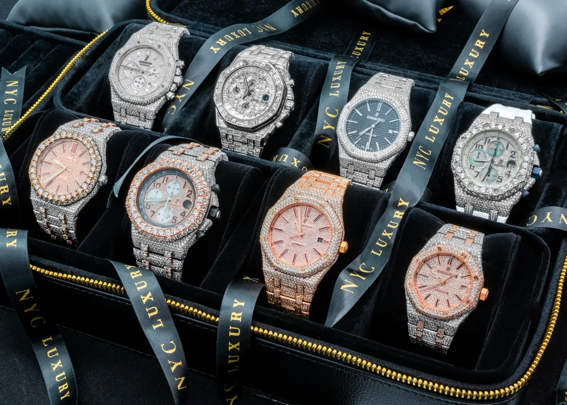 Jewelry case holding eight luxury watches, each with jeweled bands and faces. Black velvet interior with ribbon.