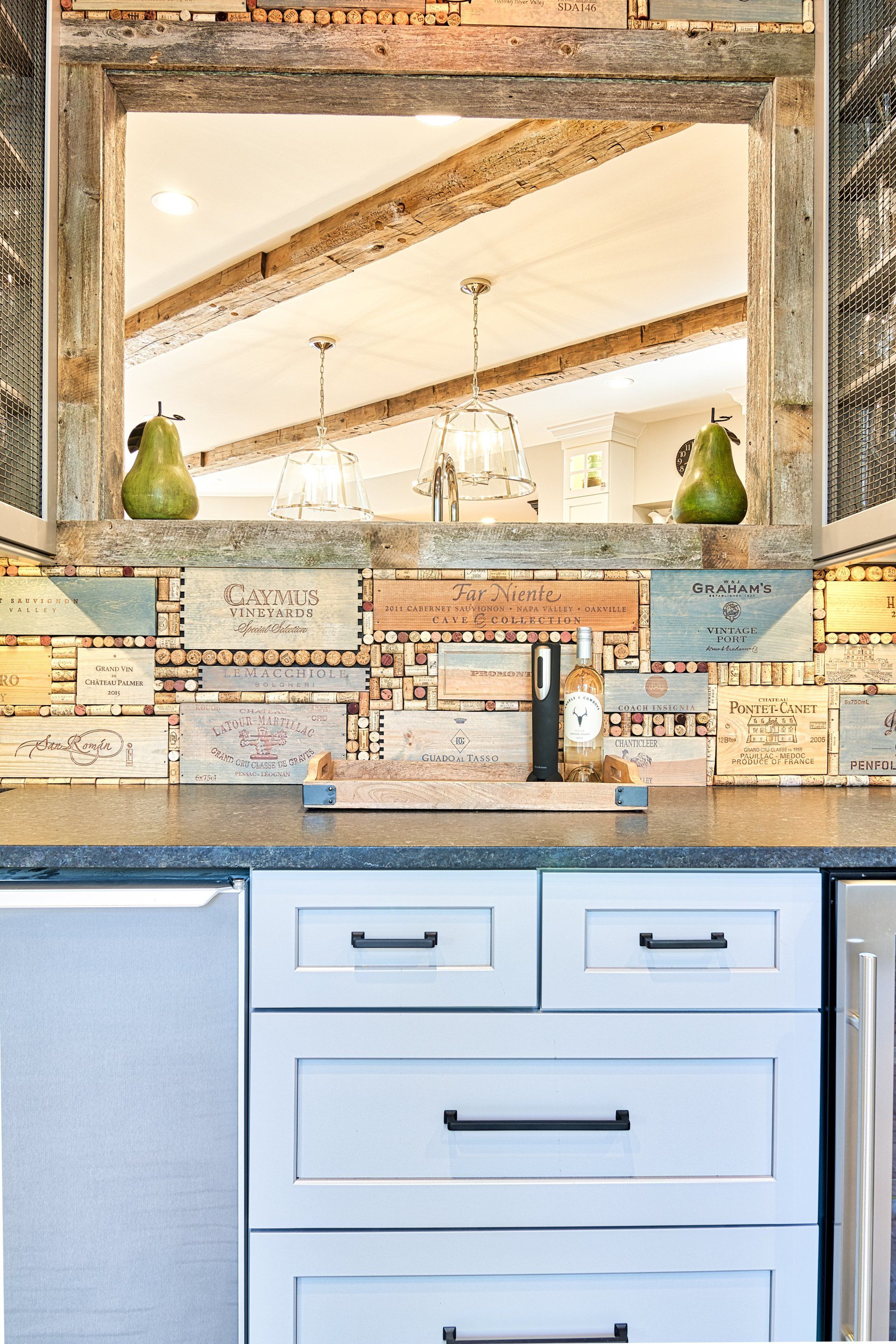 A kitchen with a large mirror above the sink