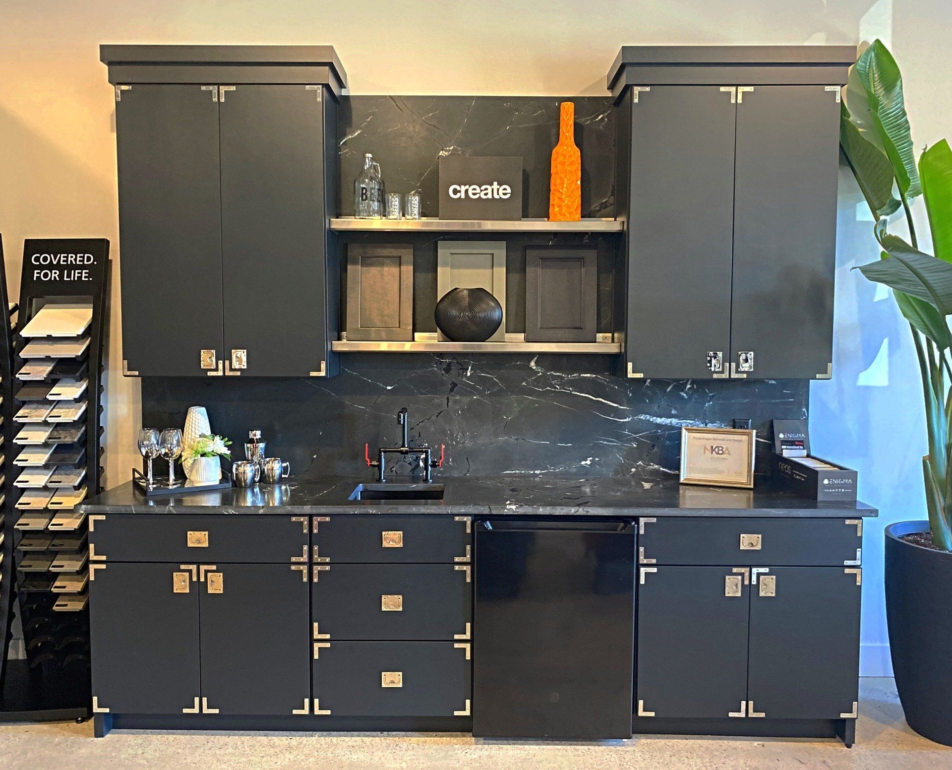 A kitchen with black cabinets and a black dishwasher