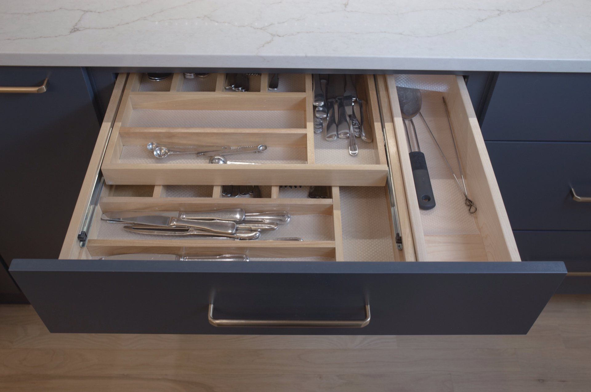 A kitchen drawer filled with silverware and utensils.