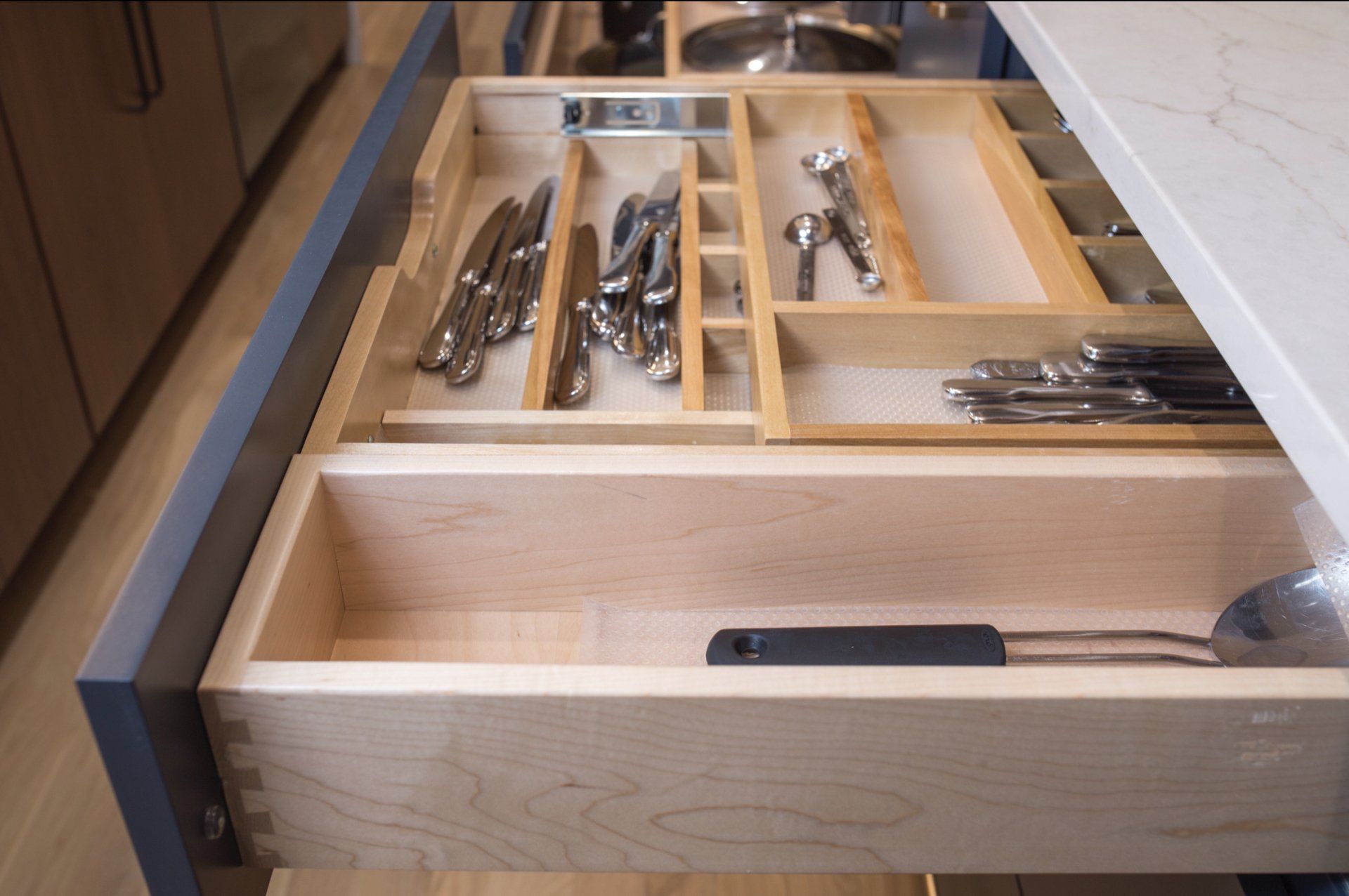 A kitchen drawer filled with silverware including knives and forks