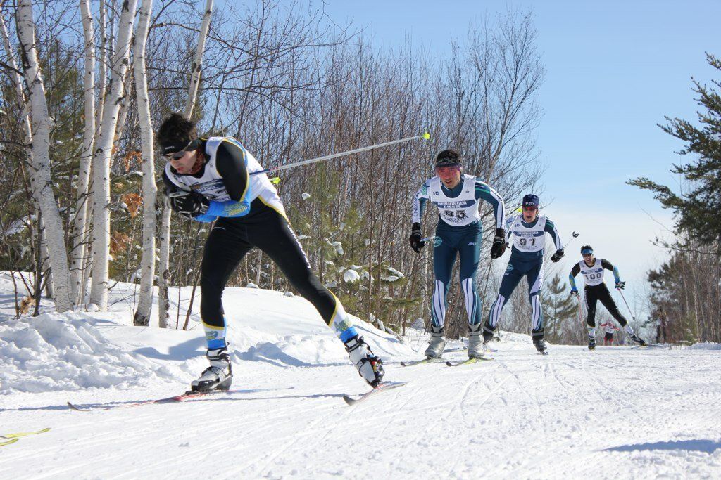 A group of people skiing down a snow covered hill
