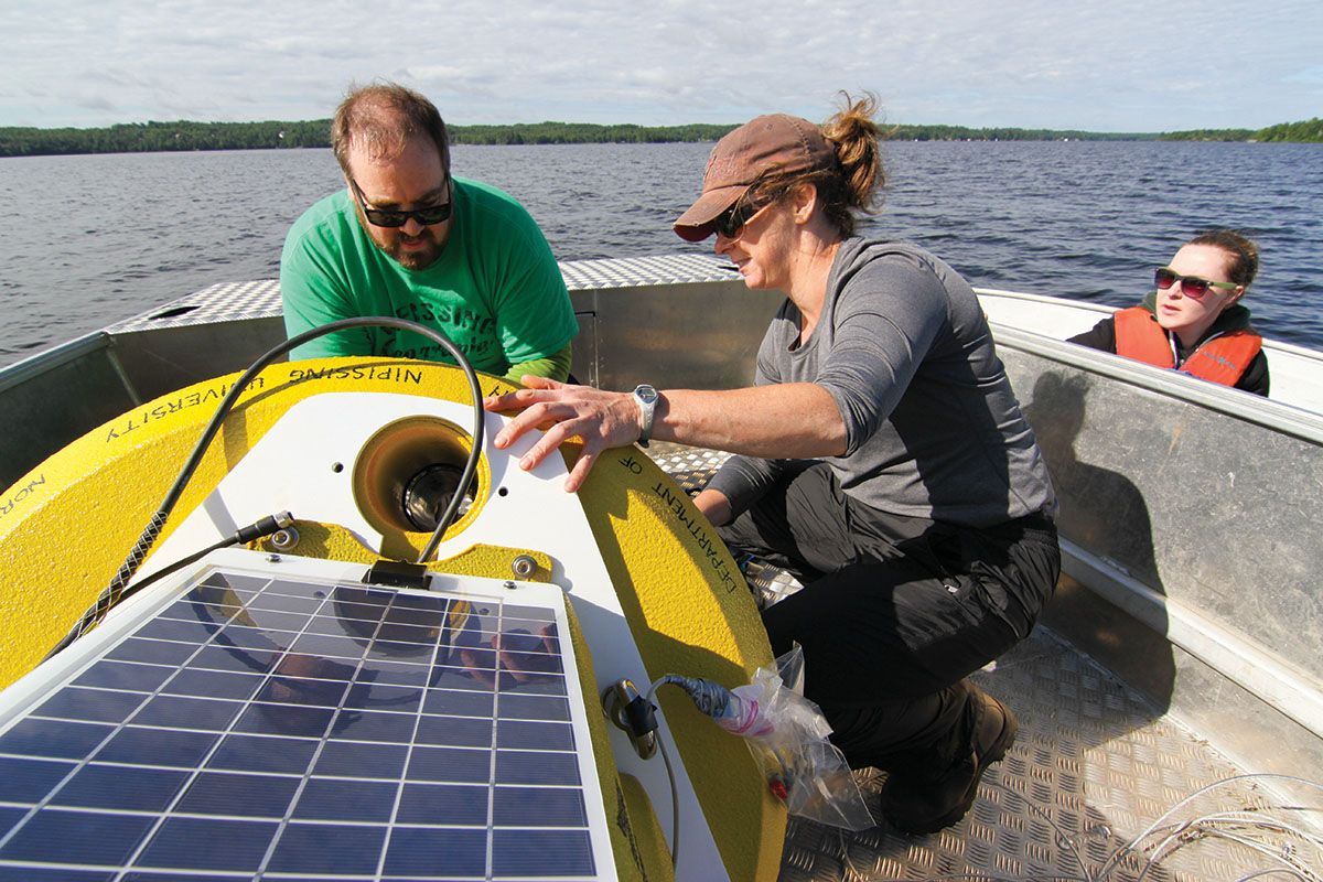 Students and professors learning on a boat