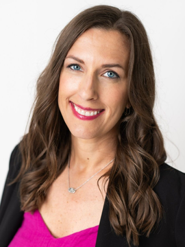 Woman smiling, long brown hair, looking at camera.