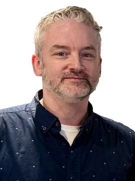Man with glasses and a beard, looking at the camera.