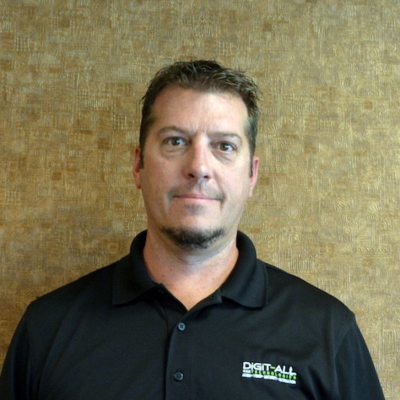 A man wearing a black shirt with the word digital on it