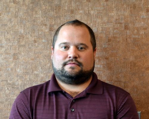 A man wearing a black shirt with the word digital on it