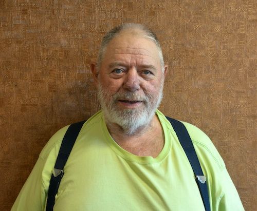 A man wearing a black shirt with the word digital on it