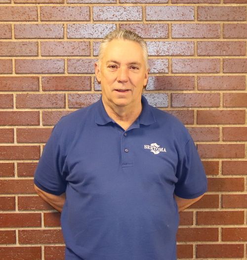A man wearing a black shirt with the word digital on it