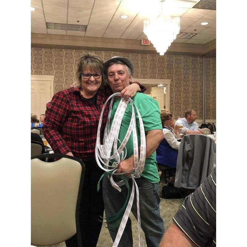 A man and a woman are standing next to each other holding a rope.