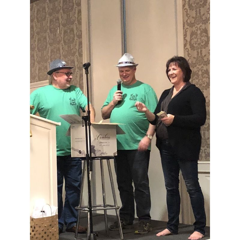 A man wearing a hard hat is speaking into a microphone