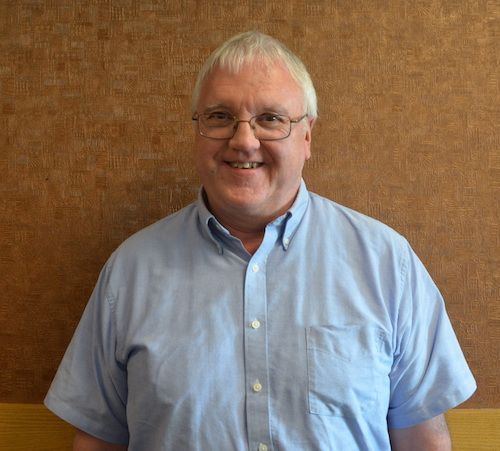 A man wearing a black shirt with the word digital on it